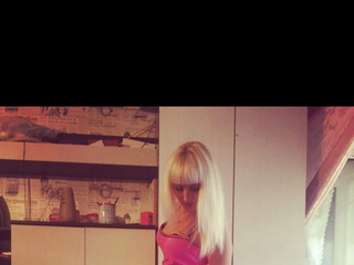 In a pink dress, stockings and pink heels