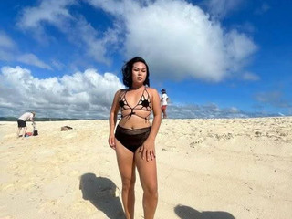 At the beach wearing bikini