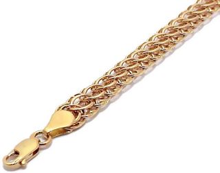 Gold bracelet on the arm.